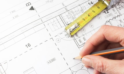 tape measure and pencil on a house drawing