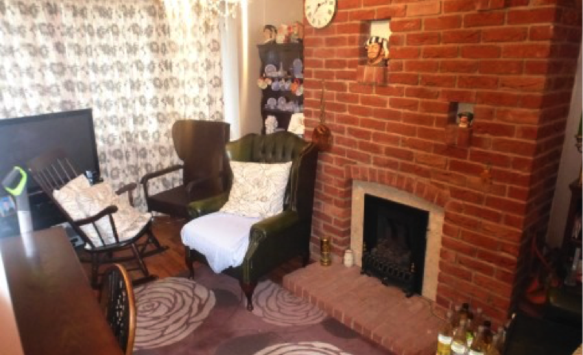 Living room with brick fireplace