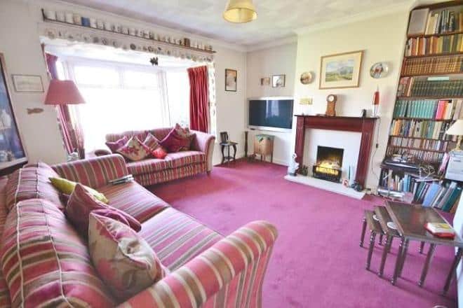 living room with pink carpet