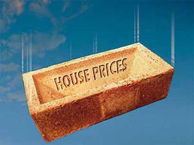 Brick with 'house price' on it falling