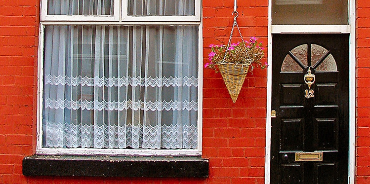 red brick wall and a black door