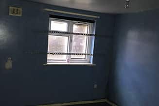 Window with a dark blue wall.