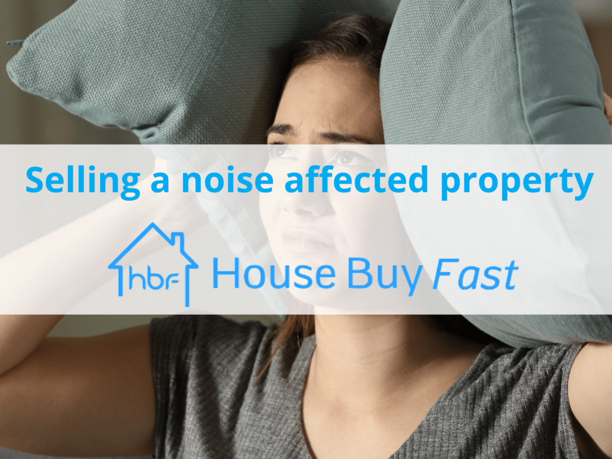 woman covering ears with pillows